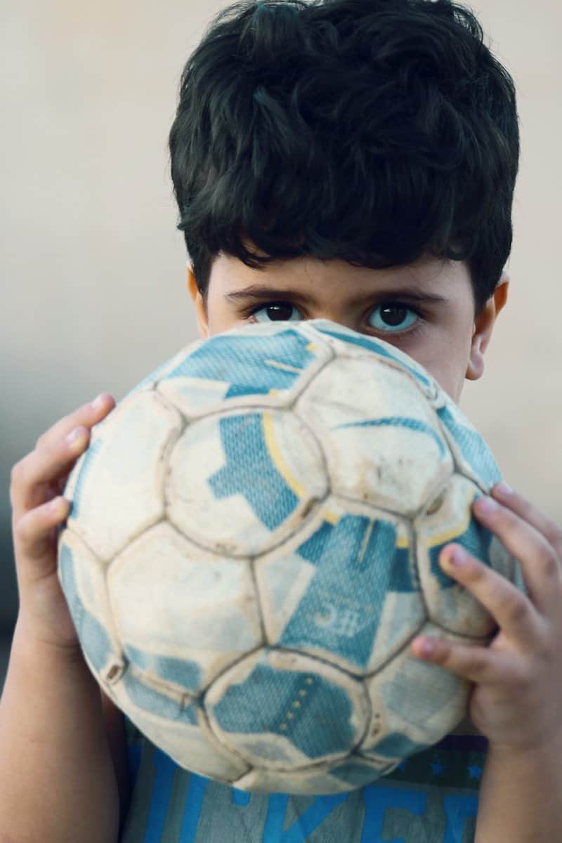 boy in white and blue soccer ball
